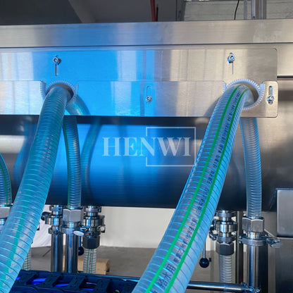 Henwi HWFM-T-4 Four Nozzles Tracking Model Automatic Liquid Bottling Filling Packing Machine 4 Heads Bottle Moving Filler